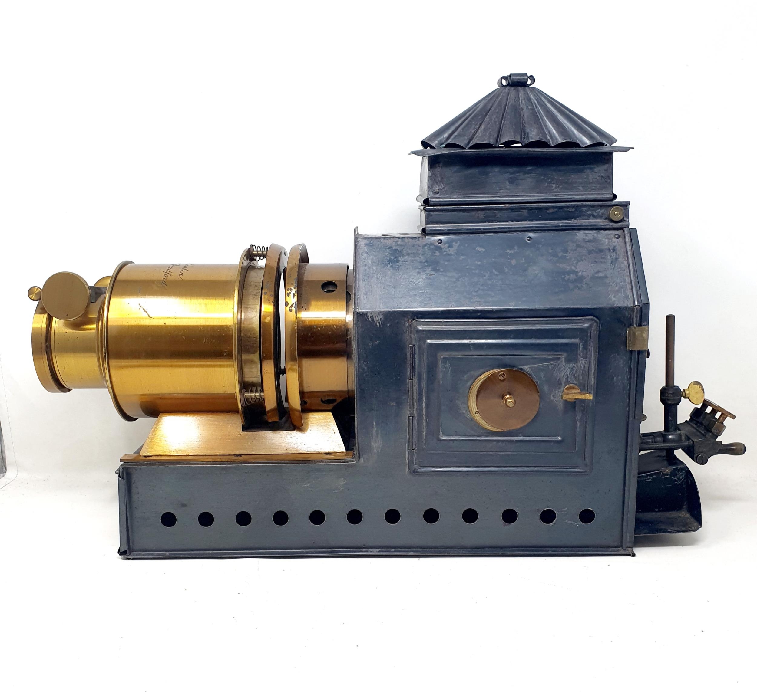 A Praestantia magic lantern, in a metal case, with a parafin burner