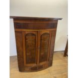 A 19th century bow front mahogany hanging corner cupboard, 94 cm wide