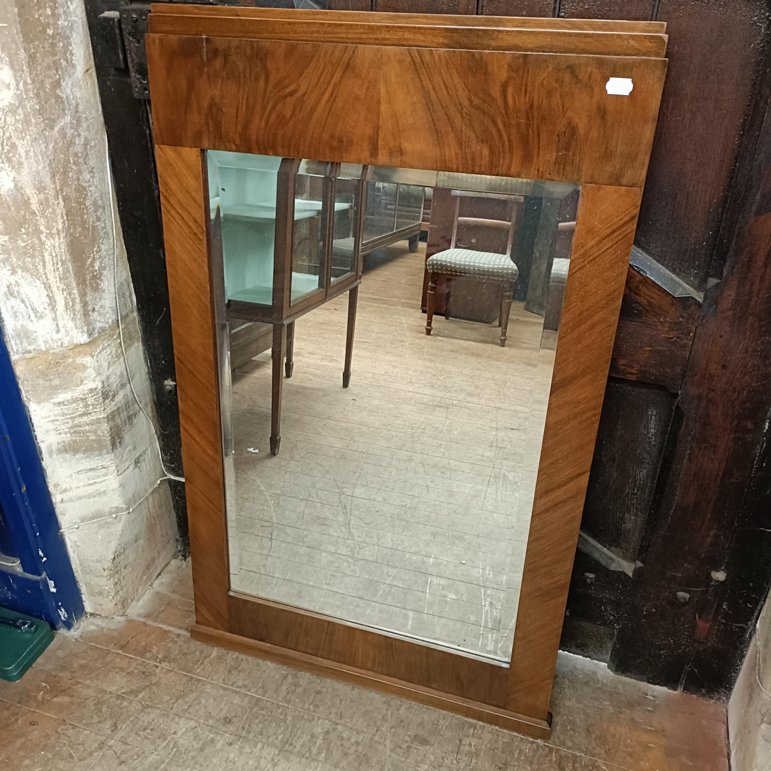 A 1920s French walnut wall mirror, 124 x 75 cm