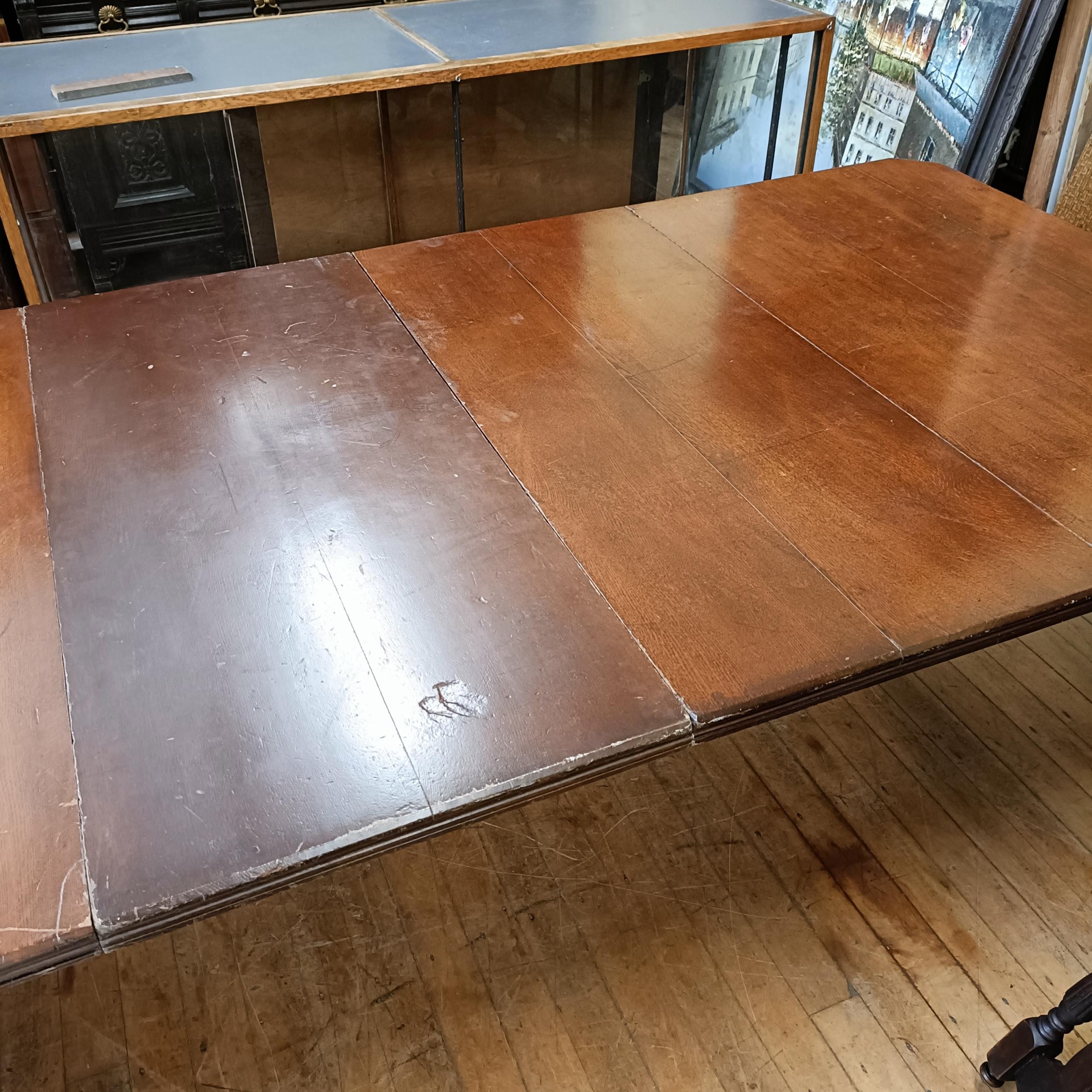 An early 20th century oak extending dining table, with two extra leaves, the top 124 cm wide The - Image 2 of 5