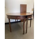 A mahogany D end dining table, on turned tapering legs, 125 cm diameter, with an extra leaf, 48 cm
