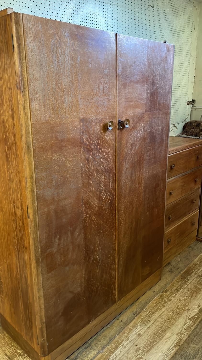 A mid 20th century oak chest, having four drawers, 106 cm high x 44 cm deep x 74 cm wide, a matching