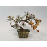 A Chinese model of a tree, with glass petals, in a gilt metal and enamel planter, 13 cm high