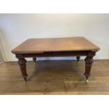A mahogany extending dining table, the top 155 cm x 105 cm, with two extra leaves, leaves: 46cm