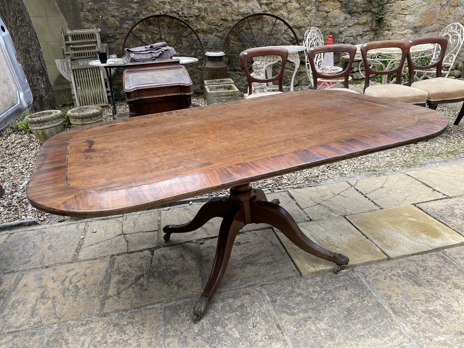 A mahogany tilt top breakfast table, crossbanded in rosewood, the top 67 x 102 cm