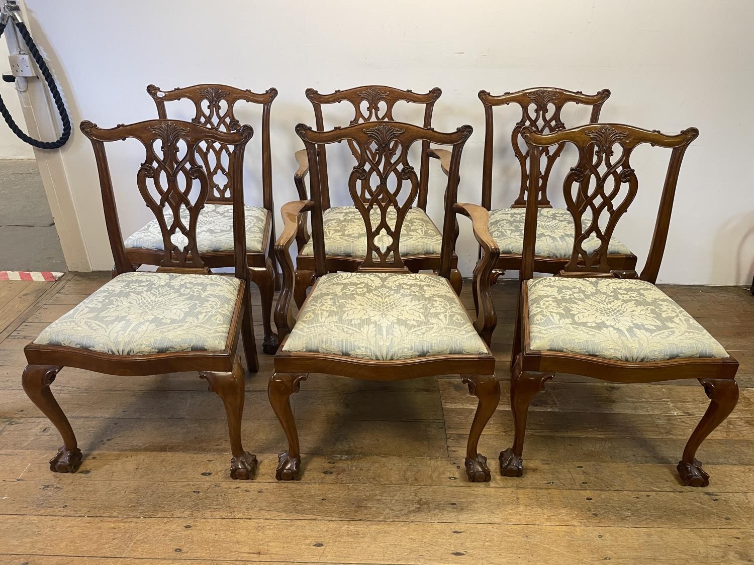 A set of six Chippendale style mahogany dining chairs with pierced splats, drop in seats, cabriole
