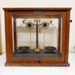 A set of Griffin & George Ltd laboratory scales, in an oak case, 46 cm wide