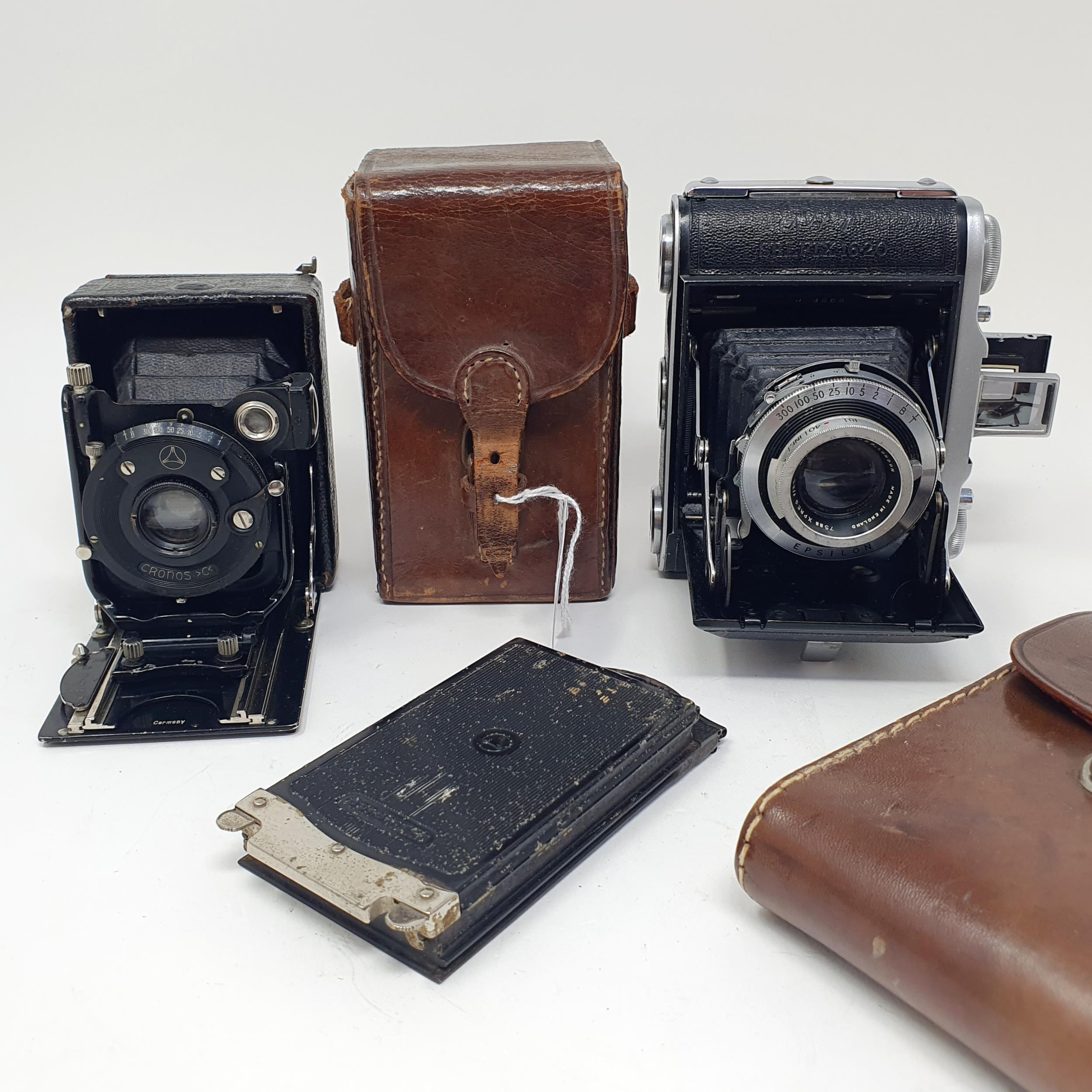 A Cronos C4 camera, in leather case, a Ensign Selfix 16-20 camera, and a leather carry case (3)