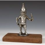 An early 20th century silver plated car mascot, in the form of Mr Punch, mounted on a wooden base,