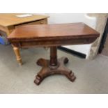 A mahogany folding card table, on a column support, a shaped base and scroll feet, 91 cm wide