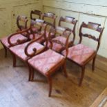 A set of seven Regency simulated rosewood dining chairs, inlaid with cut brass, on sabre legs, an
