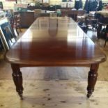 A Victorian mahogany extending dining table, on turned tapering legs, the top 190 x 147 cm, with