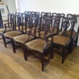 A matched set of fourteen Chippendale style mahogany dining chairs, with carved top rails, pierced
