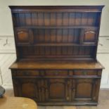 A Titchmarsh & Goodwin oak dresser, the plate rack with two cupboards and shelves, on a base with