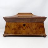 A 19th century walnut tea caddy, the hinge top to reveal marquetry inlaid caddies, and a later cut