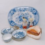 A Worcester blue and white tea bowl, 7 cm wide, assorted blue and white saucers, a carved conch