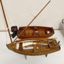A wooden model of a clinker built boat, 50 cm wide, and another, 50 cm wide (2)