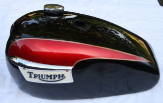 An export petrol tank for Triumph Bonneville T140V/T140E, complete with badges and tank cap being