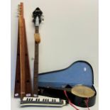 The Yetties Mac McCulloch's ukulele, a Hohner Melodica cased, a banjo neck, and another