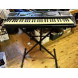 A Yamaha keyboard and stand, assorted music books, and Fender guitar calendars (qty)