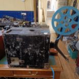 A portable cinematic projector, in a painted wooden case Provenance: From a vast single owner