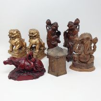 A pair of Chinese carvings of men, 20 cm high, a figure of a bull, a box, a pair of dogs and a