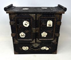 An early 20th century Japanese table top cabinet, applied Satsuma panels, decorated birds, having