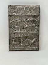 An Indian silver coloured metal card case, decorated animals, 105 g