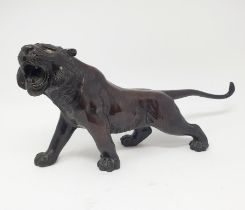 A Japanese bronze tiger, signed, 38 cm wide In our opinion we think this is a 20th century copy