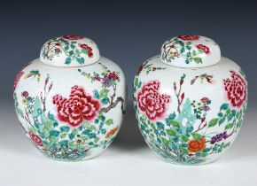 A pair of Chinese famille verte ginger jars and covers, decorated flowers and butterflies, 22 cm