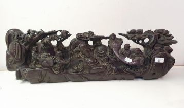 A Chinese carving, decorated figures, 82 cm wide