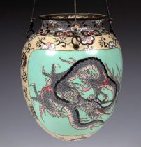 A Japanese cloisonné hanging pot, of ovoid form, decorated a dragon, 23 cm high Small loss to the