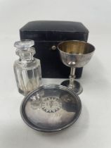 A late 19th/early 20th century communion set, comprising a stand, a cup, and a cut glass bottle,