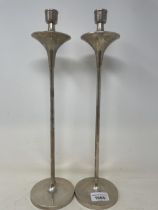 A pair of modern silver candle sticks, filled, 40 cm high