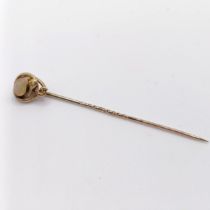 A late 19th/early 20th century yellow metal and opal stick pin, in the form of a snake Provenance: