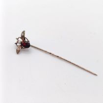 A late 19th/early 20th century yellow metal red stone and seed pearl stick pin, in the form of a fly