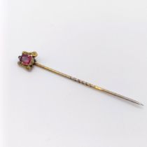 A late 19th/early 20th century yellow metal and garnet stick pin Provenance: From a single owner