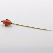 A 20th century yellow metal, coral and white stone stick pin Provenance: From a single owner