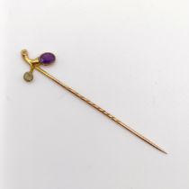 A late 19th/early 20th century yellow metal, amethyst and peridot stick pin Provenance: From a