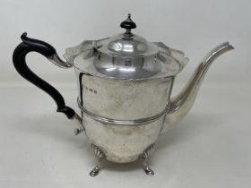 A George V silver teapot, with an ebonised handle, and a Continental sliver coloured metal salt,