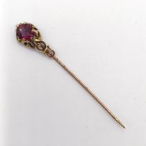 A late 19th/early 20th century yellow metal and garnet stick pin Provenance: From a single owner