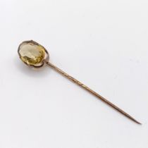 A 20th century yellow metal and tanzanite stick pin Provenance: From a single owner collection of