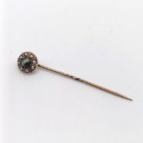 A late 19th/early 20th century yellow metal, seed pearl and tiger's eye stick pin Provenance: From a