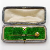 A late 19th/early 20th century diamond stick pin, and a yellow metal button, in a vintage