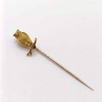 A late 19th/early 20th century yellow metal stick pin, in the form of an owl perched on a twig
