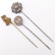 A brass stick pin, in the form of a female bust, and two silver stick pins (3) Provenance: From a