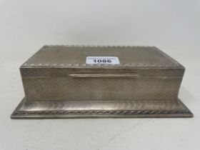 A silver table cigarette box, with presentation inscription and engine turned decoration, London