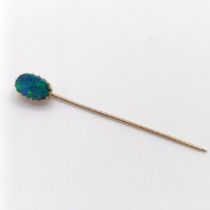 A 20th century, yellow coloured metal and opal stick pin Provenance: From a single owner
