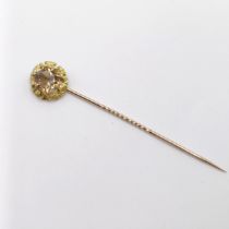 A 20th century yellow metal and yellow stone stick pin Provenance: From a single owner collection of