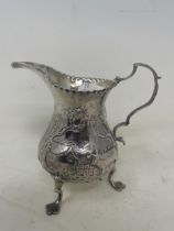 A George III silver cream jug, embossed a farm, swans and a cow, London 1771, 2.6 ozt